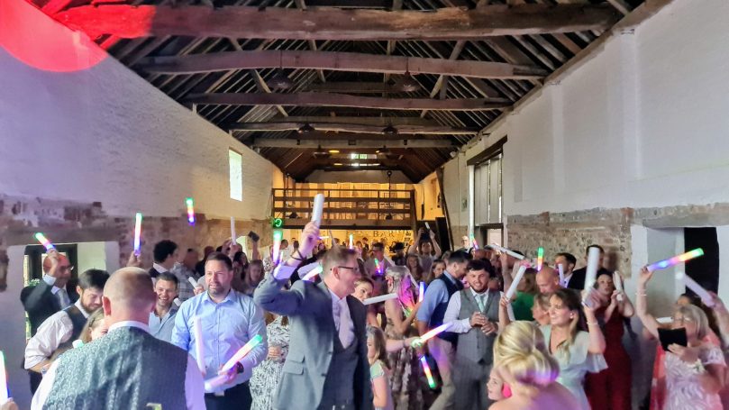 Wedding party with DJ Gary Sulter in Norfolk waving lit up batons